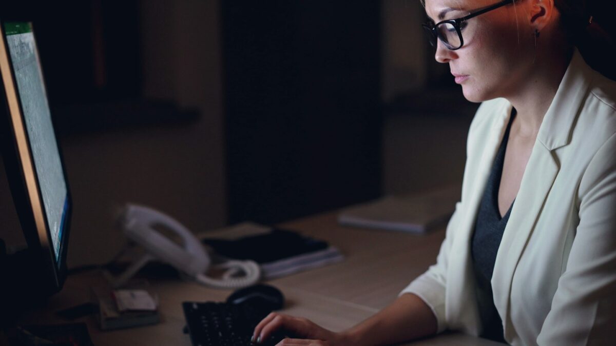 Woman working on computer at night