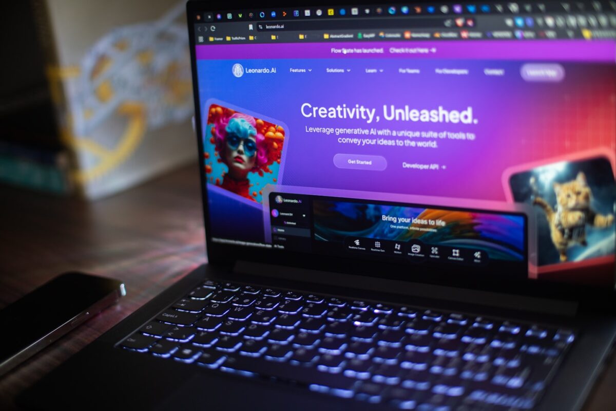 A laptop shows a website about ai creativity