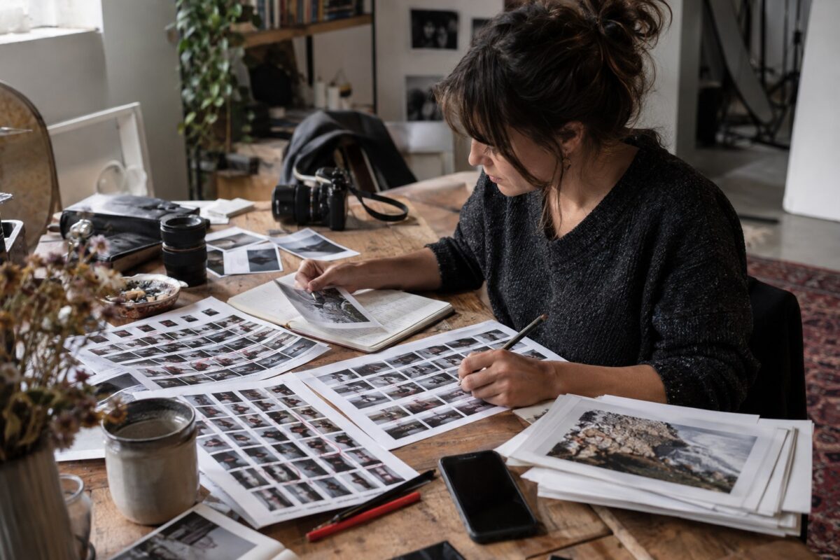 Creator selecting photos and drafting captions after a shoot
