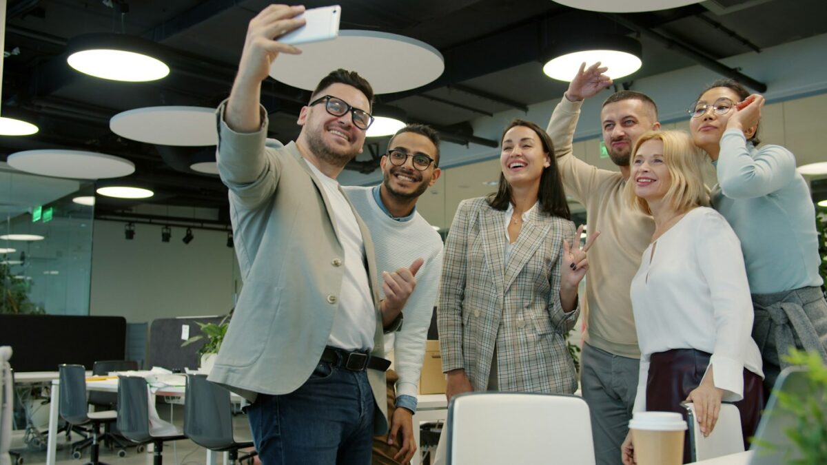 Group of colleagues taking a selfie in the office