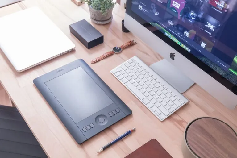 Musician website on a laptop shown beside an artist portrait in a creative workspace