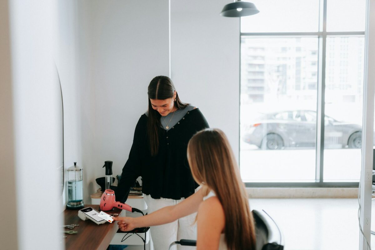 A hairstylist is working on a customer's hair