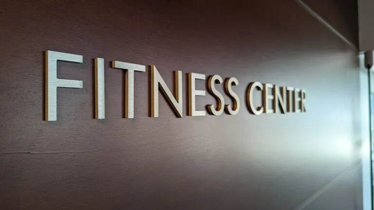 Fitness studio owner in a modern branded workspace, representing fitness business marketing that turns leads into...