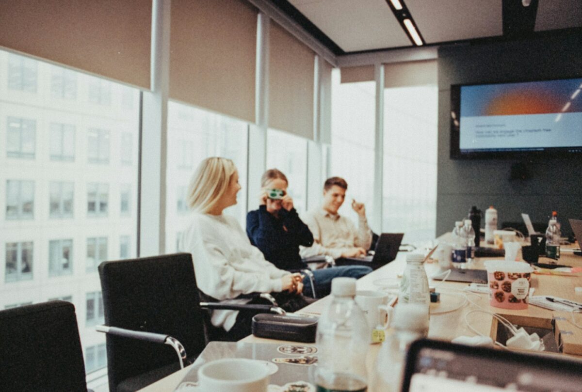 a group of people sitting around a conference room table