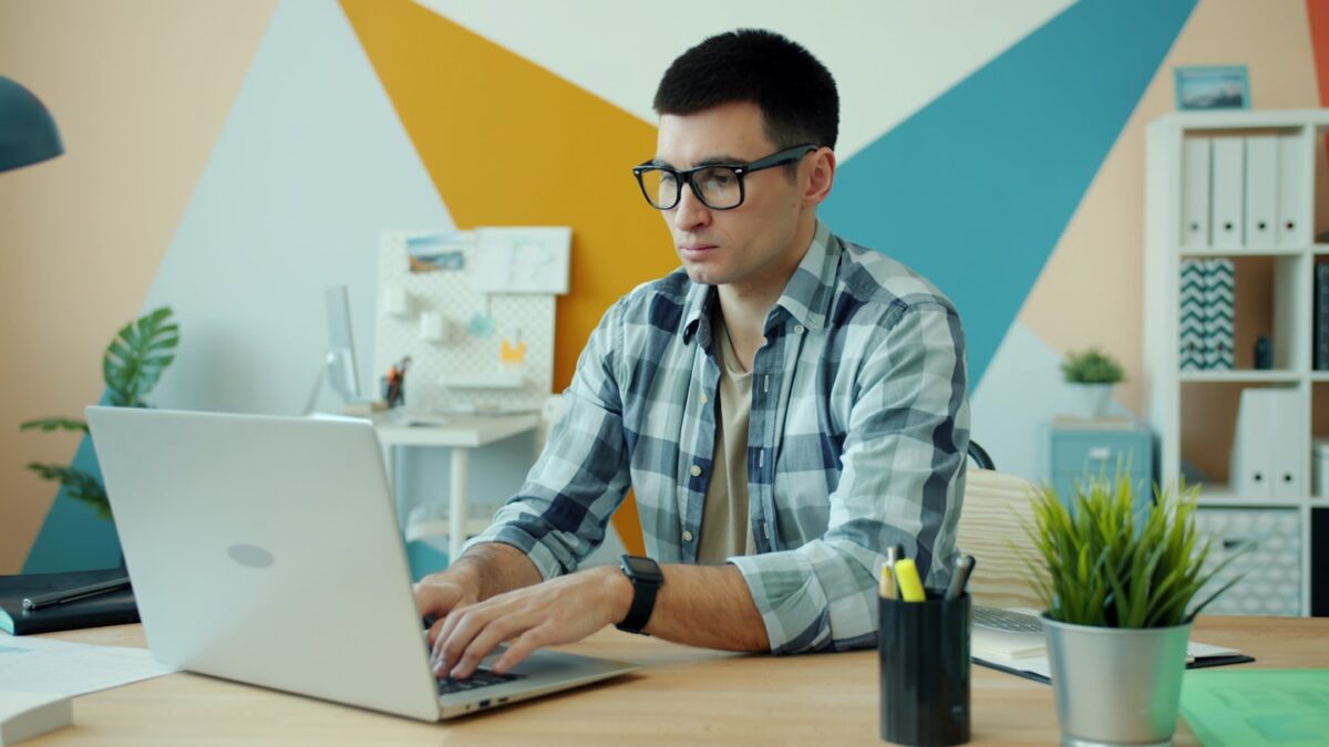Man working on a laptop in a colorful office