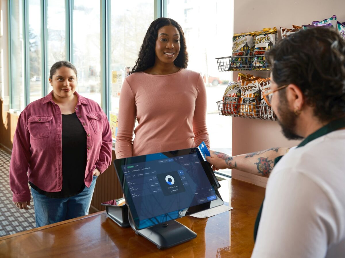 Customers interacting with a cashier and a point-of-sale system
