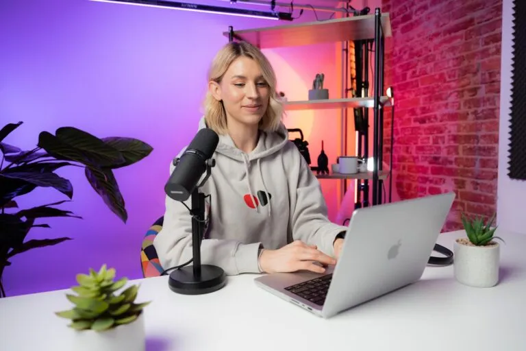 Adult creator platform launch concept with a branded studio setup and a content monetization interface on screen