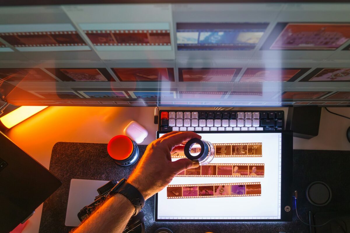 Person examining film negatives on a light table